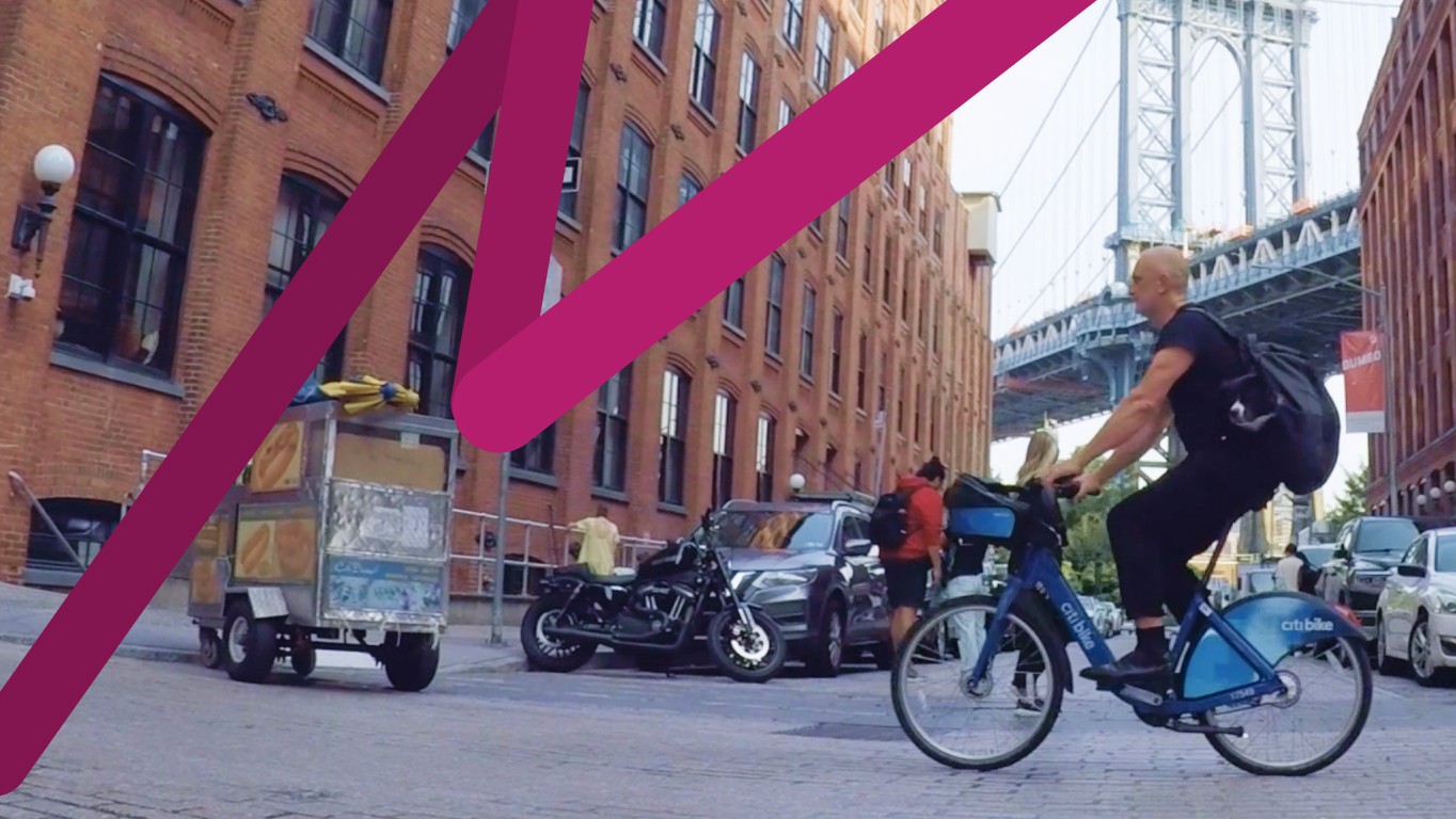 A screengrab of the video with Bruce riding a Citibike through the DUMBO neighborhood of Brooklyn, NY.